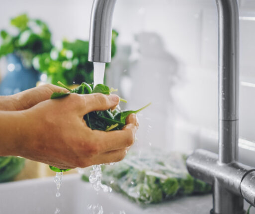 Close,Up,Shot,Of,A,Man,Washing,Green,Spinach,Leaves